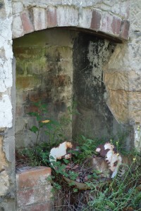 An old fire place and washing bowl, all that remains of one of the guest houses