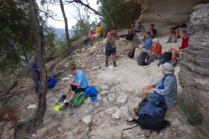 The group resting for morning tea under a huge overhang at the base of the escarpment