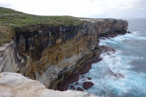 Stunning coast line marked by high colourful cliffs and a crashing surf down below