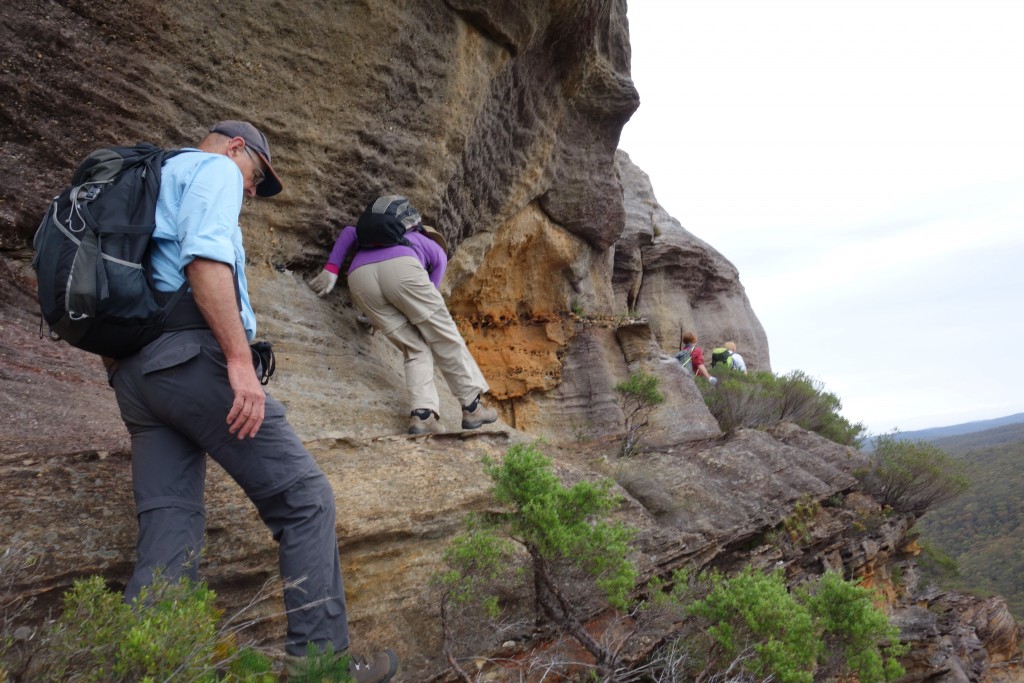 Julie in her familiar purple carefully negotiating a ledge which gave us access to the top of the crags