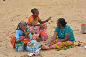 Women on the beach in Negombo wearing colourful clothes