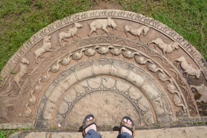 An ancient moonstone dating back over 1,000 years and still used today as a stepping stone to an old temple