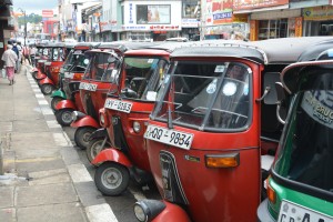 Privately owned tuk-tuks park in the shopping district of downtown Kandy