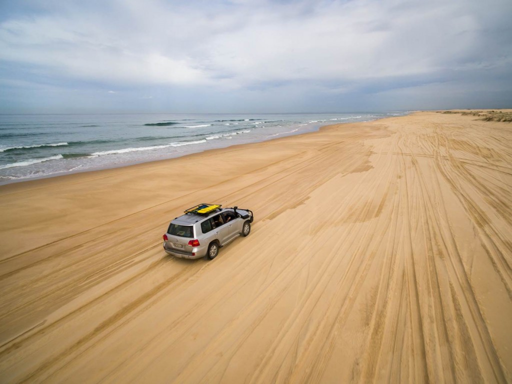 The drone follows our path along the vast reaches of Stockton Beach