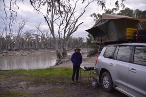 Julie at camp on the first night with our roof top tent excited to be back on the road