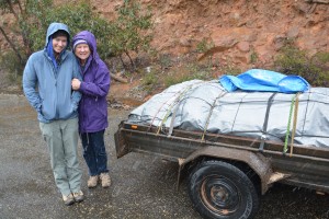 Mother and daughter reluctantly posing for a photo in the snow