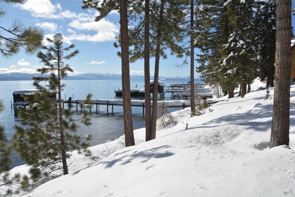 The shoreline of the lake is lined with snow covered piers