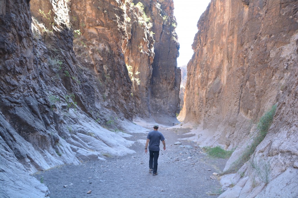 Walking through a narrow canyon formed by water rushing its way to the Rio Grande