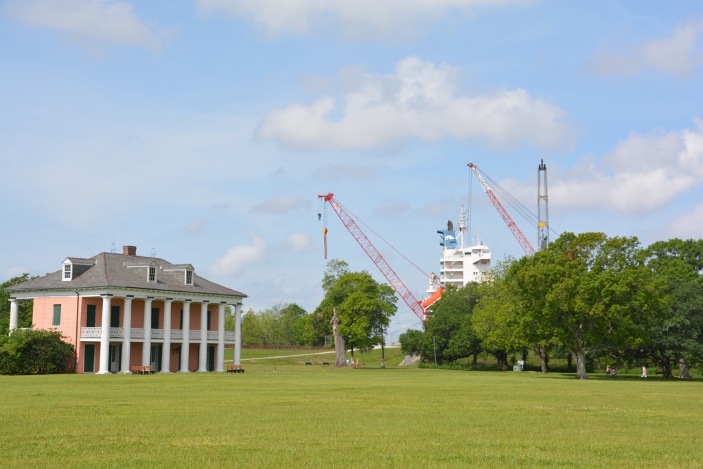 Not an illusion - a giant cargo ship behind the levy on the Mississippi dwarfs a historic homestead on the site of the famous Chawlette battlefield