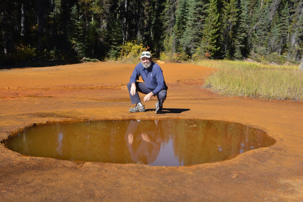 I'm balancing at the edge of a paint pot which combine with the ochre pits to create a unique experience in Kootenay National Park